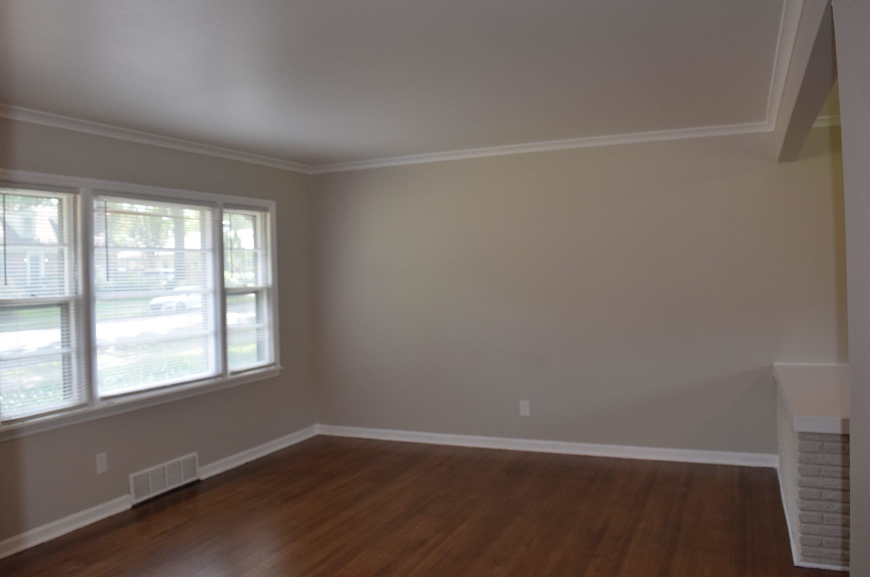 4144 Minden Road Memphis, TN 38117 - Photo 4 of 23 an empty room with wooden floor and windows
