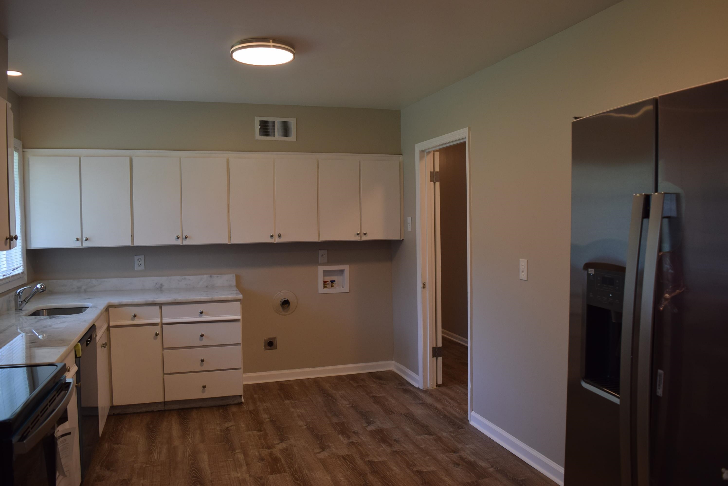 4144 Minden Road Memphis, TN 38117 - Photo 7 of 23 a kitchen with white cabinets and wooden floor
