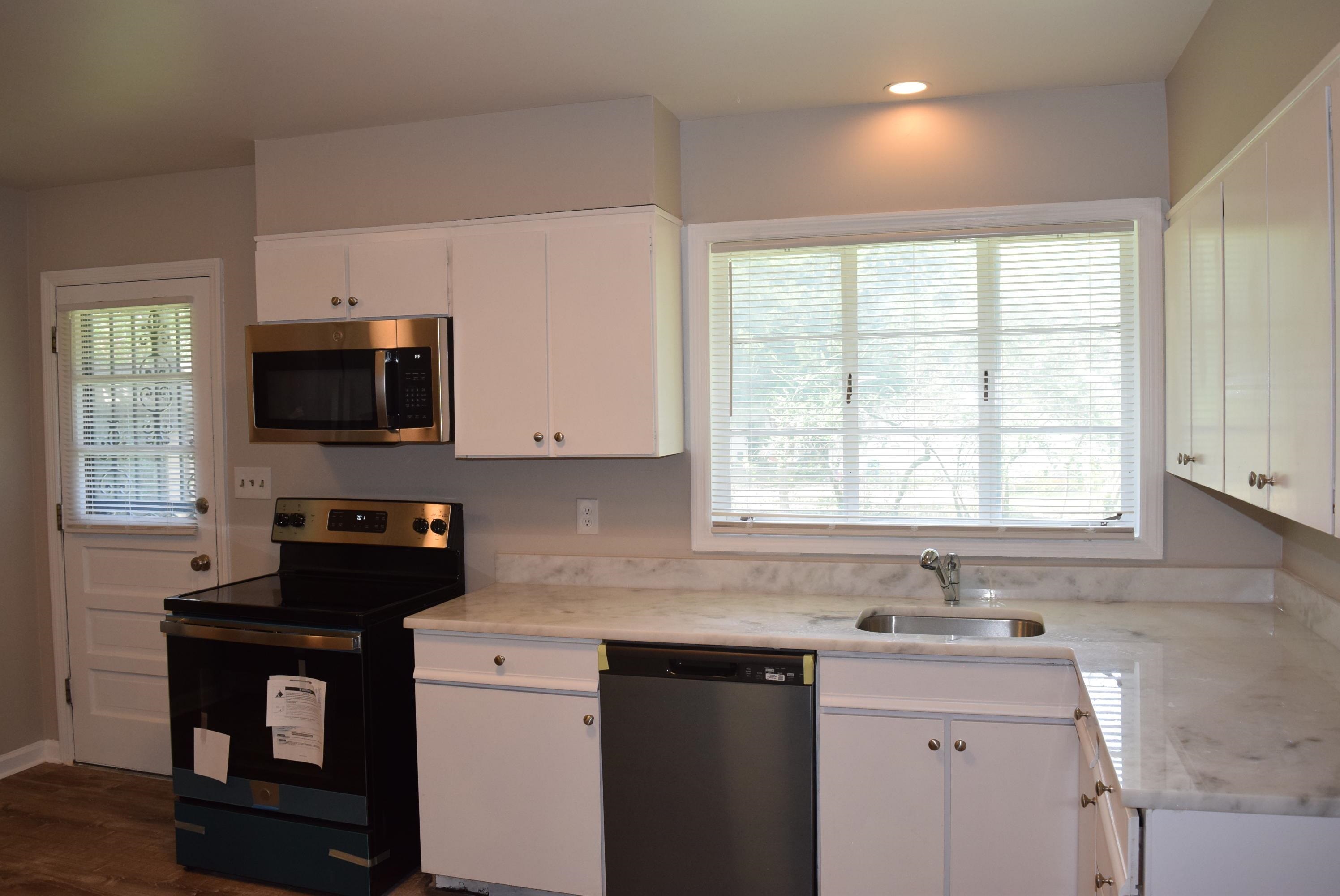 4144 Minden Road Memphis, TN 38117 - Photo 10 of 23 a kitchen with a sink a window and a microwave
