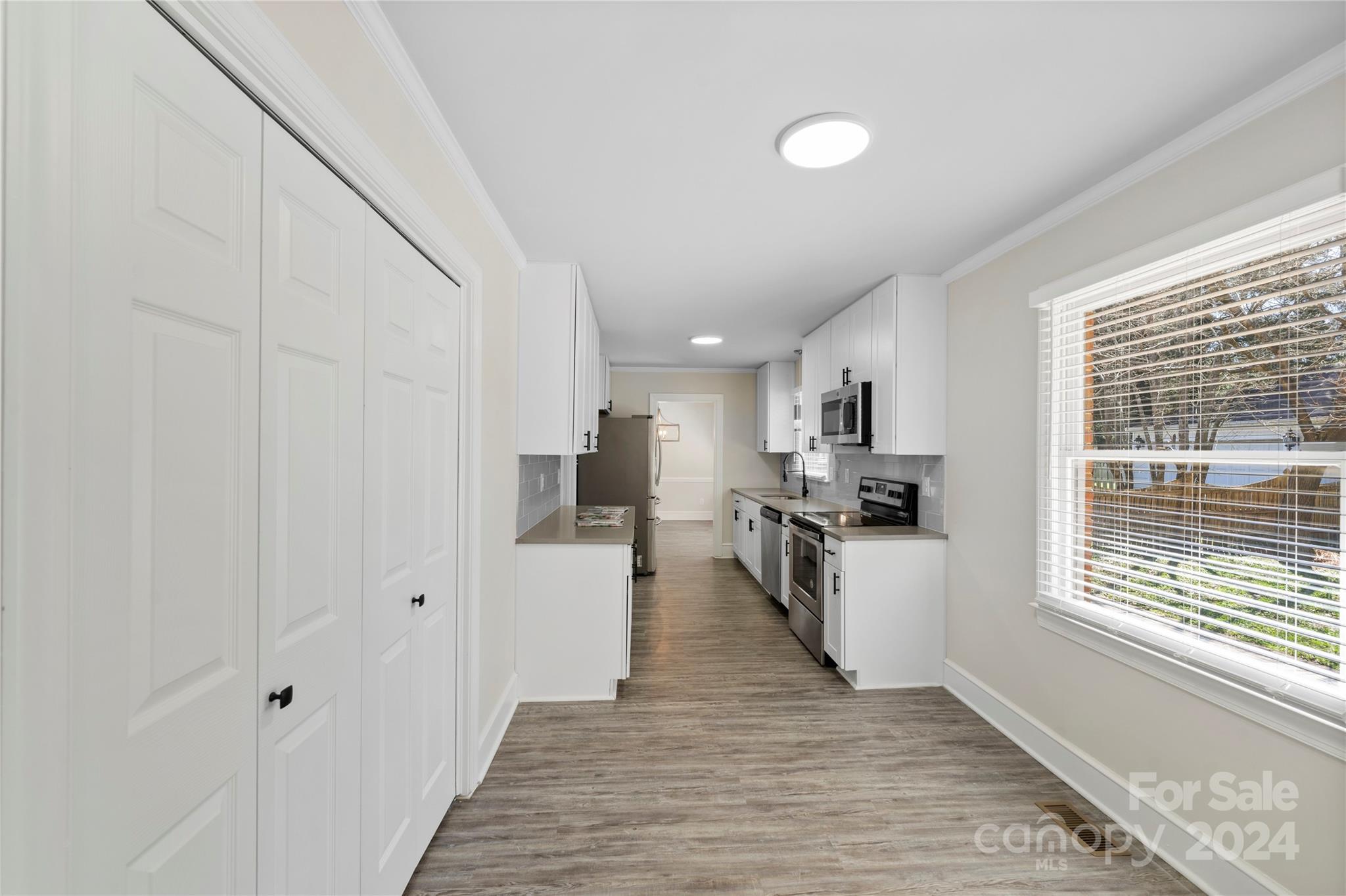 7802 Ridgeloch Place Charlotte, NC 28226 - Photo 12 of 31 a kitchen with white cabinets and window