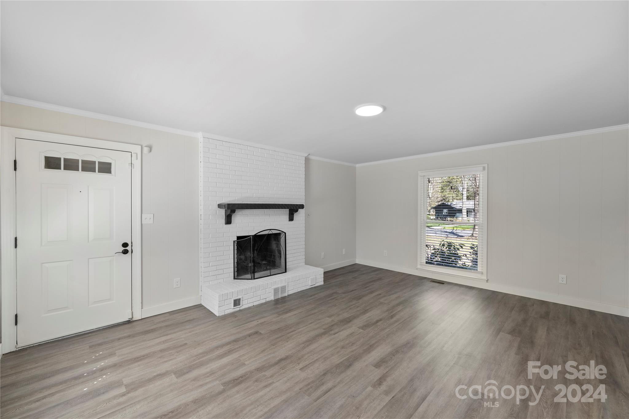 7802 Ridgeloch Place Charlotte, NC 28226 - Photo 13 of 31 a view of a livingroom with wooden floor and a fireplace