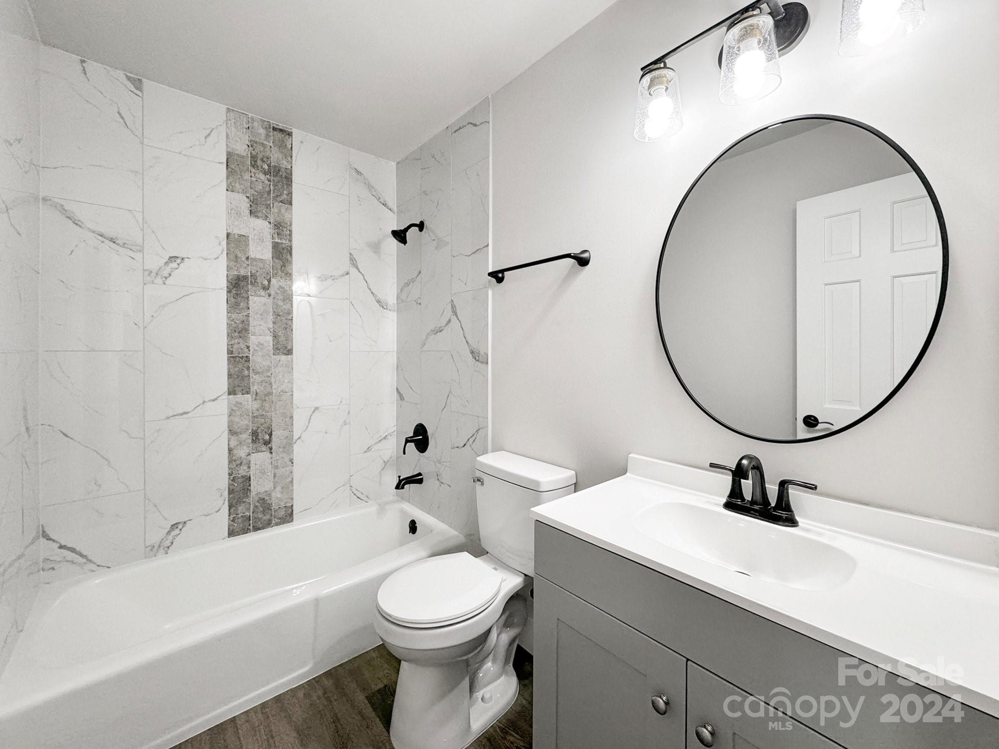 7802 Ridgeloch Place Charlotte, NC 28226 - Photo 16 of 31 a bathroom with a sink a toilet and a mirror