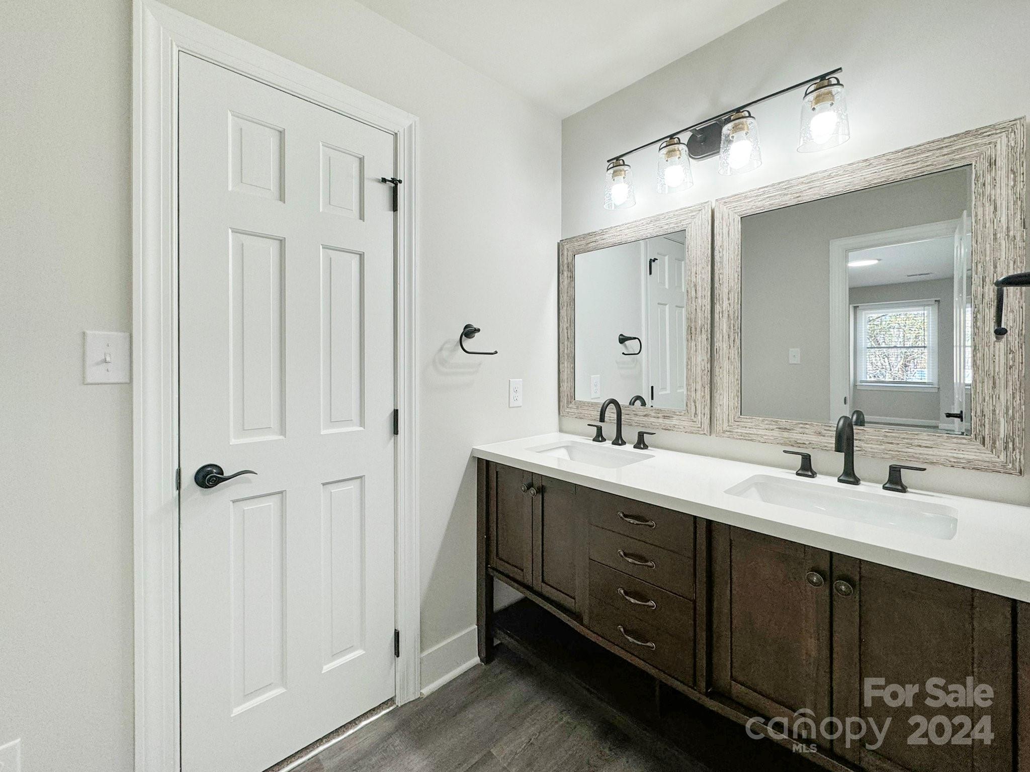 7802 Ridgeloch Place Charlotte, NC 28226 - Photo 19 of 31 a bathroom with double vanity sinks and a mirror