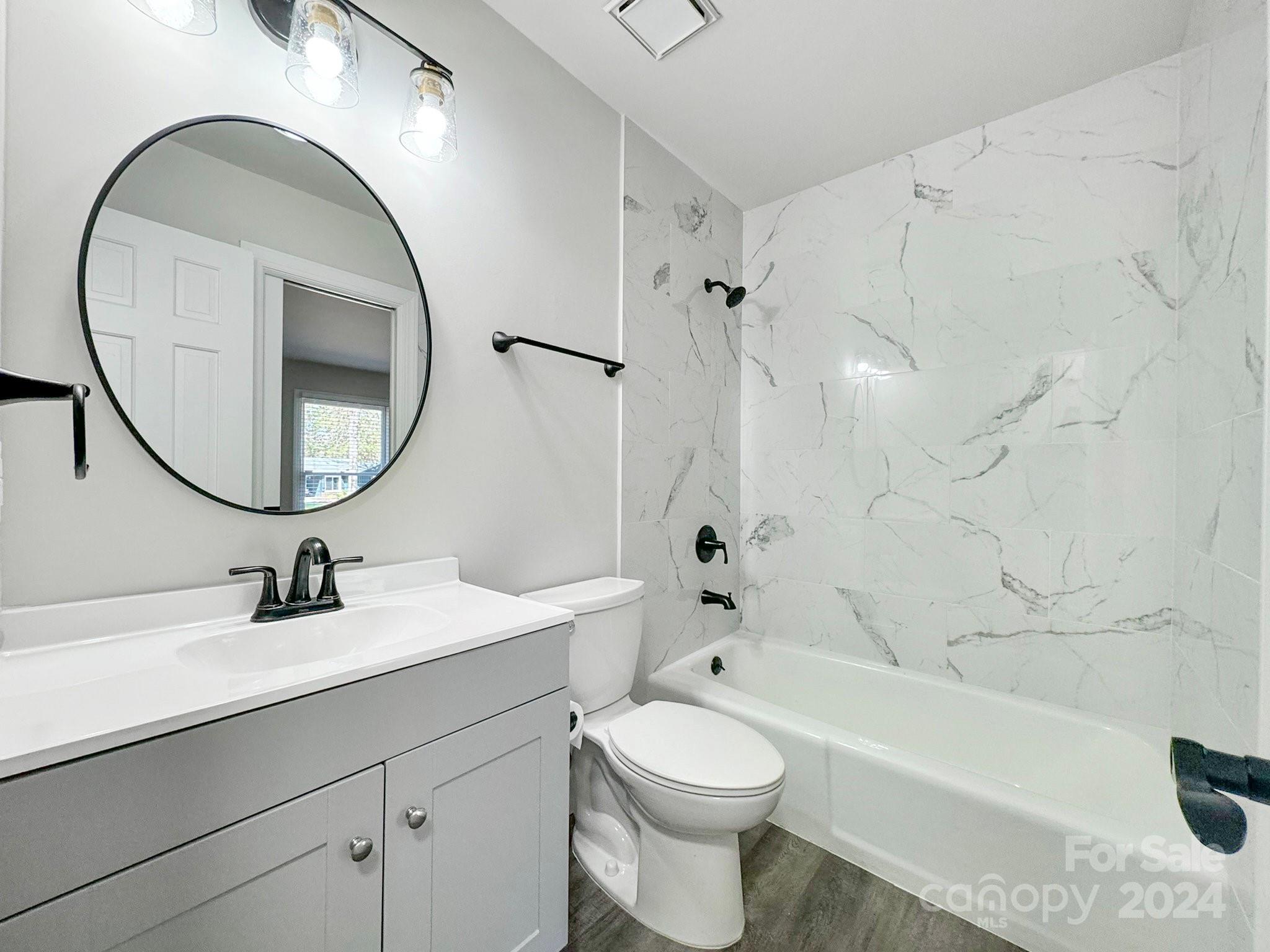 7802 Ridgeloch Place Charlotte, NC 28226 - Photo 21 of 31 a bathroom with a sink a toilet and a mirror