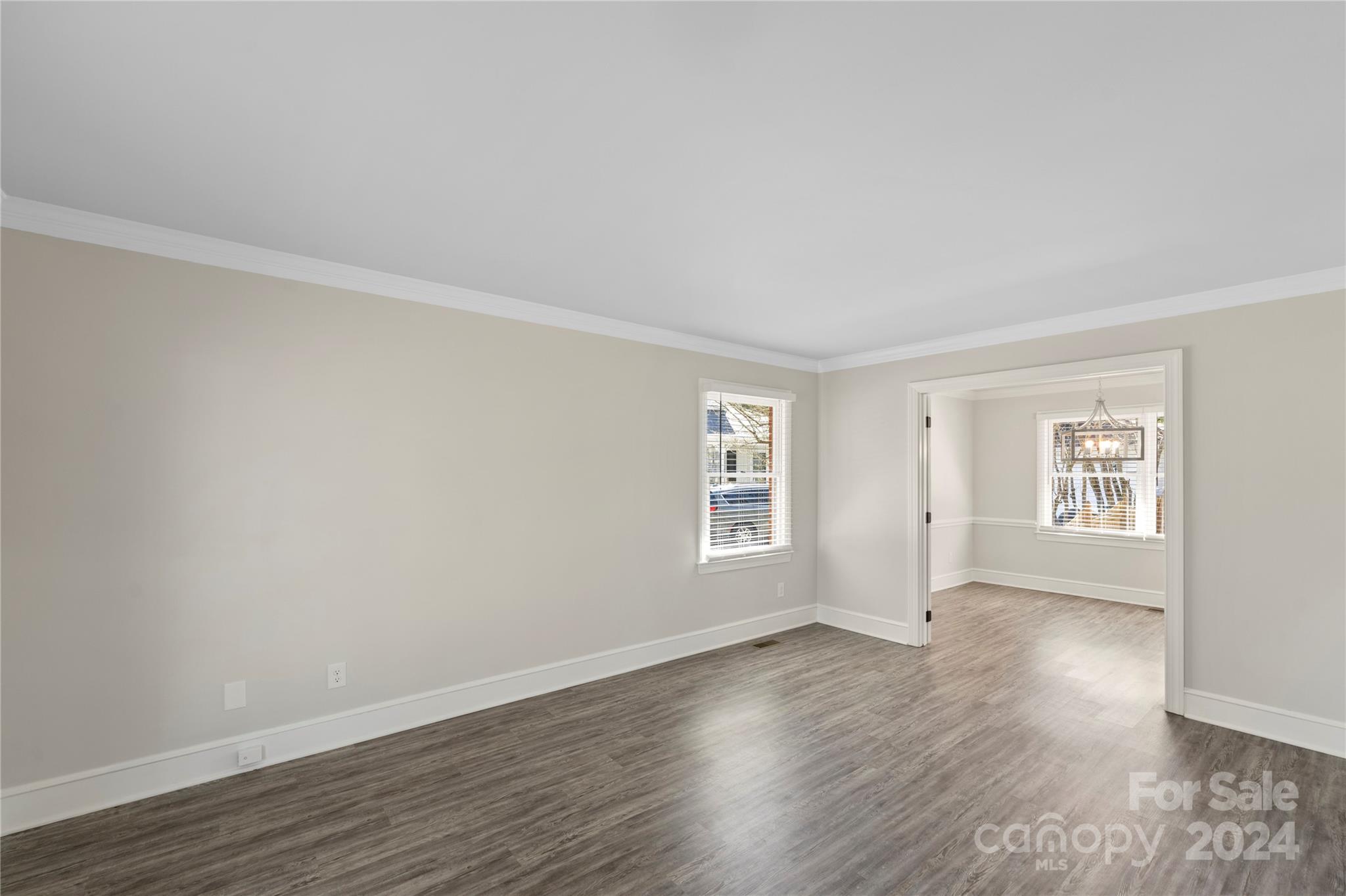 7802 Ridgeloch Place Charlotte, NC 28226 - Photo 7 of 31 an empty room with wooden floor and windows