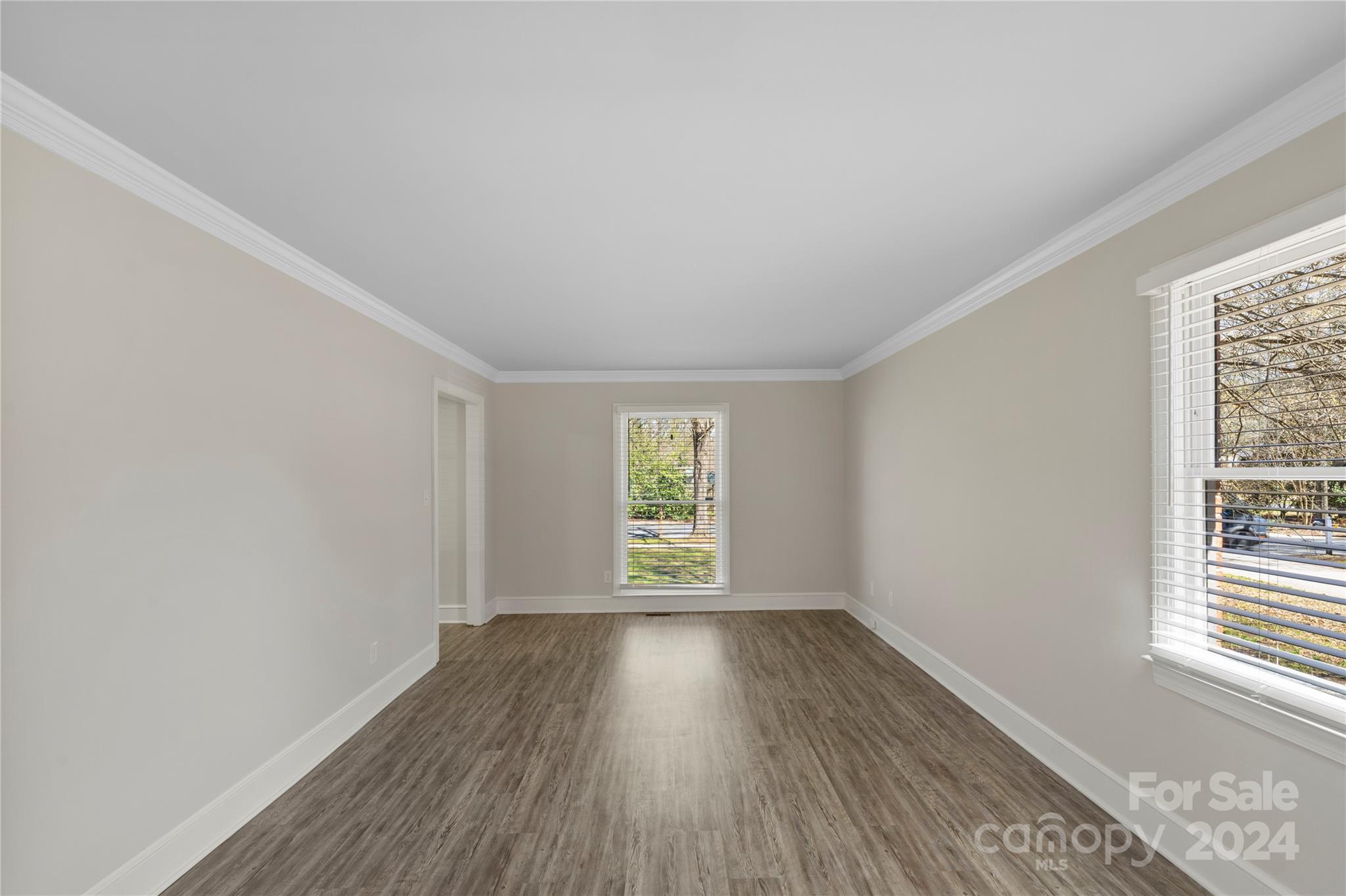 7802 Ridgeloch Place Charlotte, NC 28226 - Photo 8 of 31 an empty room with wooden floor and windows