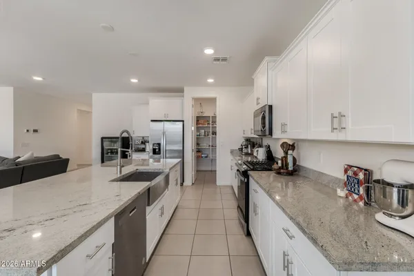 a large kitchen with stainless steel appliances lots of counter space and a sink