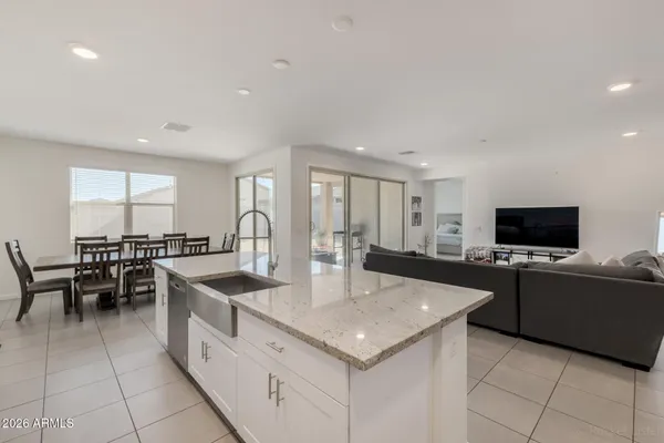 a large kitchen with kitchen island a sink table and chairs