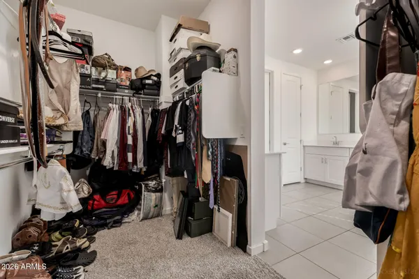 a view of walk in closet with clothes