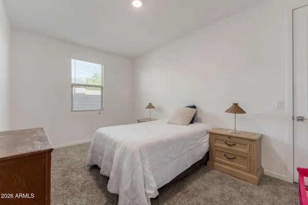 a bedroom with a bed and a dresser