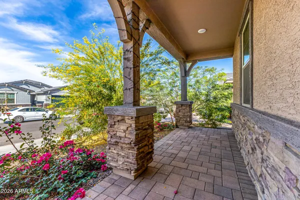 a view of entryway with flower pots and wooden fence