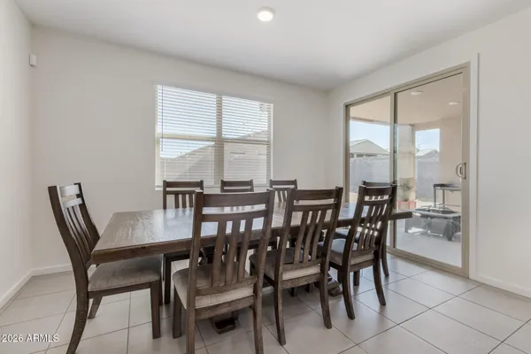 a view of a dining room with furniture and a table and chairs