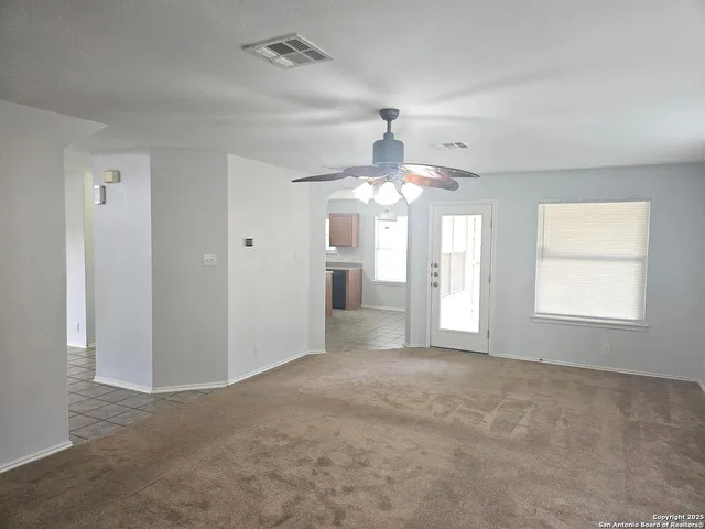 a view of staircase with white walls and white door