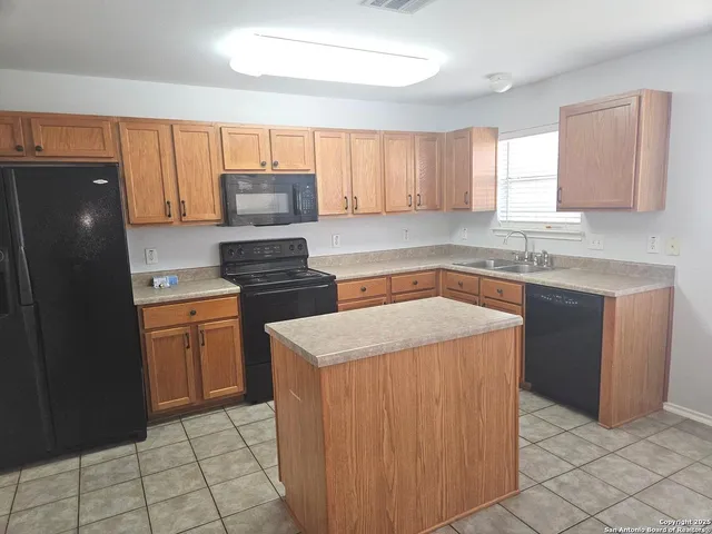 an empty room with windows and cabinet