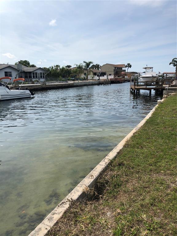 5834 Beverly Drive Hudson, FL 34667 - Photo 6 of 6 a view of a lake with houses in the back