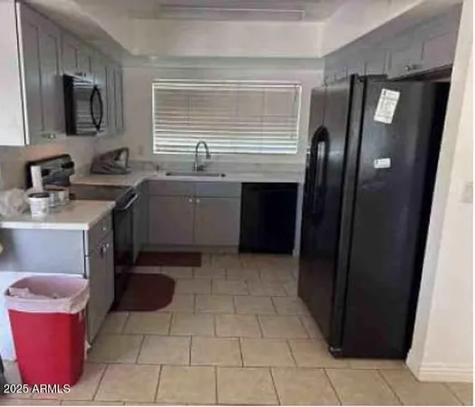 a kitchen with a sink and a refrigerator