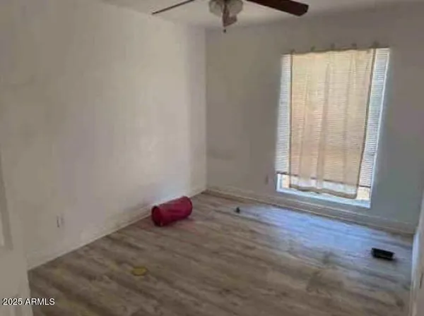 a view of a room with window and hardwood floor
