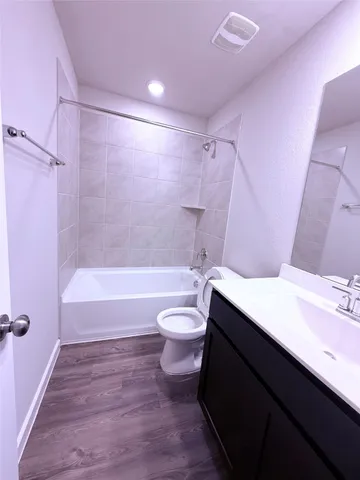 a bathroom with a sink a toilet a tub and shower