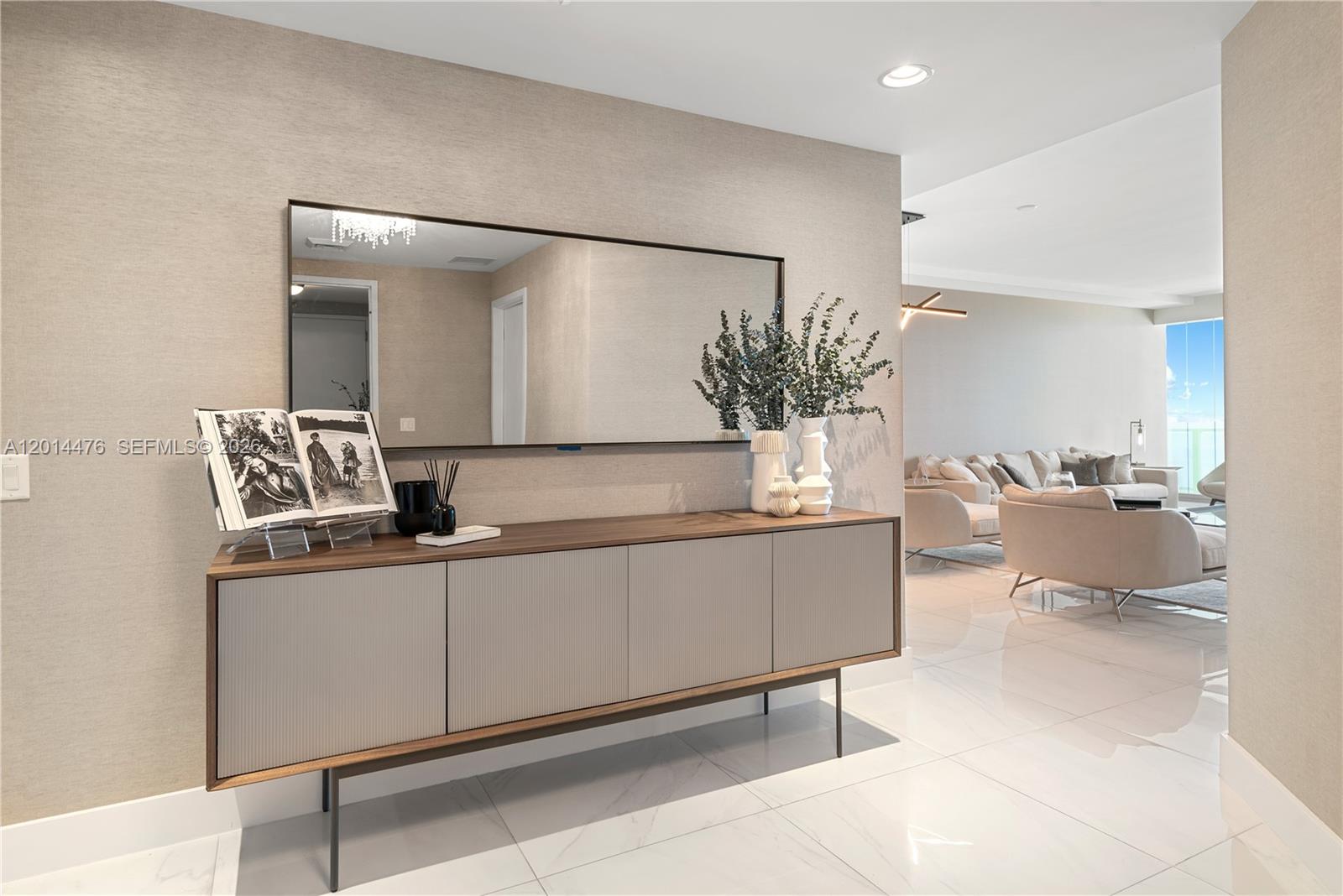 360 Ocean Drive, Unit 1106S Key Biscayne, FL 33149 - Photo 3 of 67 Entry Hall – This polished hallway features a modern console, oversized mirror, and warm neutral finishes that transition seamlessly into the living space. Clean lines and reflective surfaces add a bright, contemporary feel.