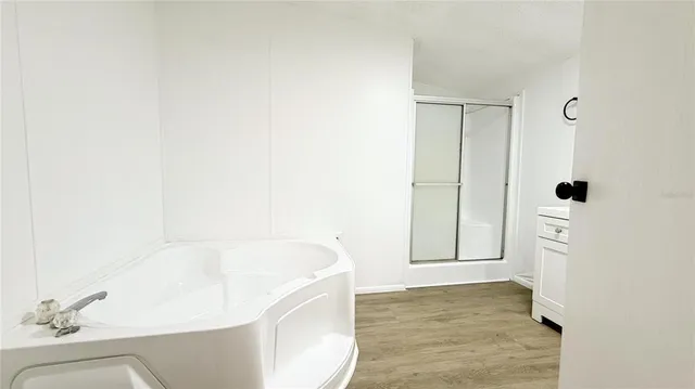 a bathroom with a bathtub and shower