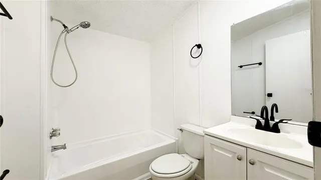 a bathroom with a sink a toilet and a shower