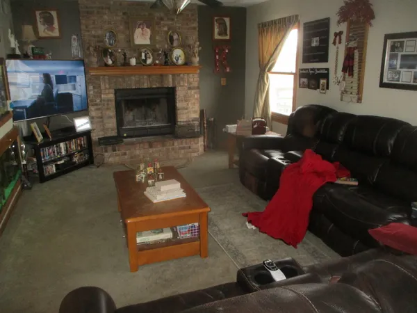 a living room with furniture fireplace and a fireplace