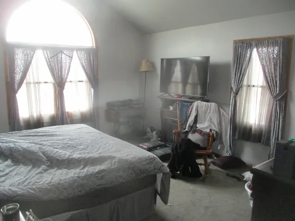 a bedroom with a bed and a mirror