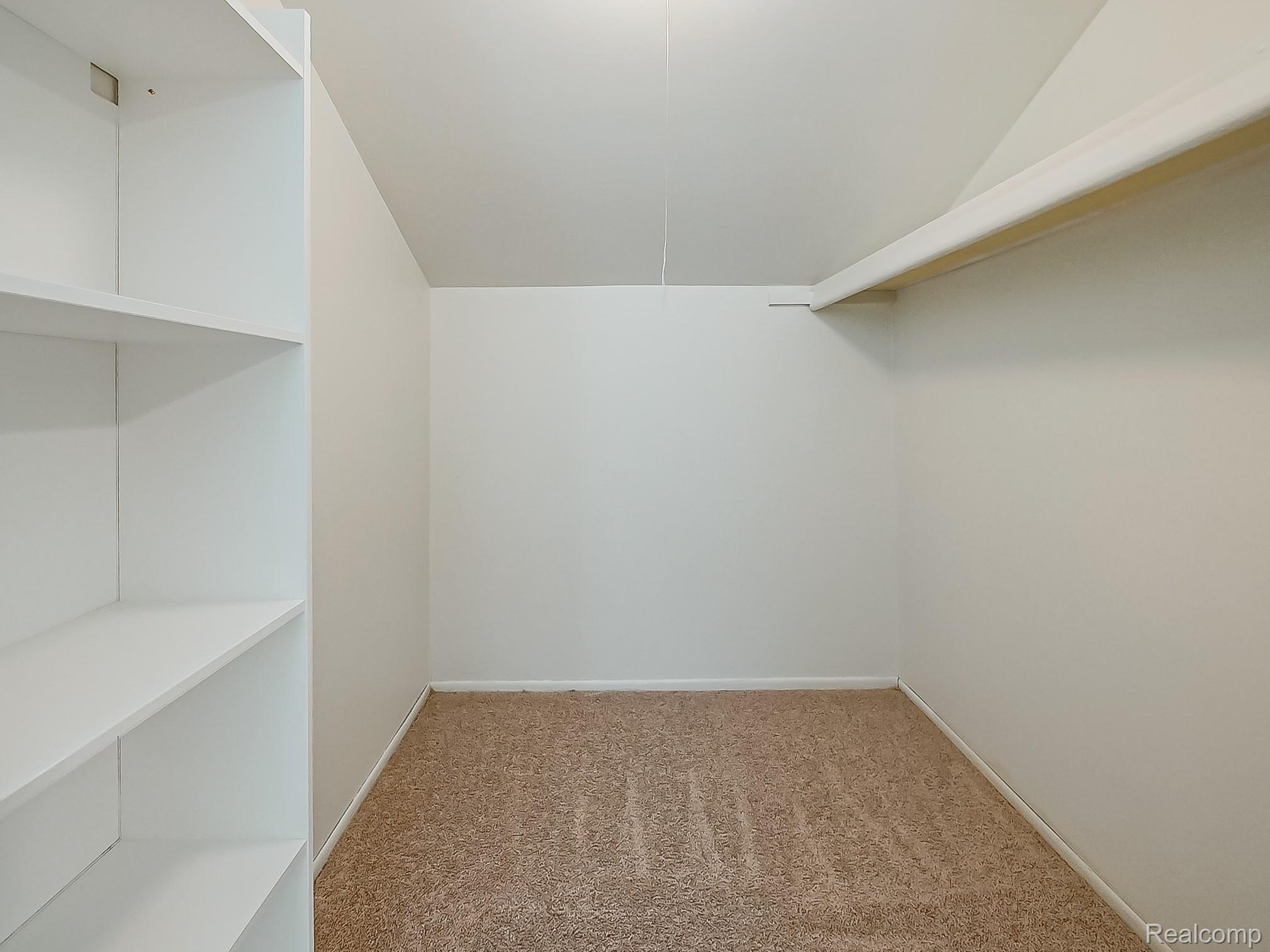 42195 Park Ridge Road Novi, MI 48375 - Photo 26 of 52 Built-in white shelving, upper storage shelf, and neutral wall paint