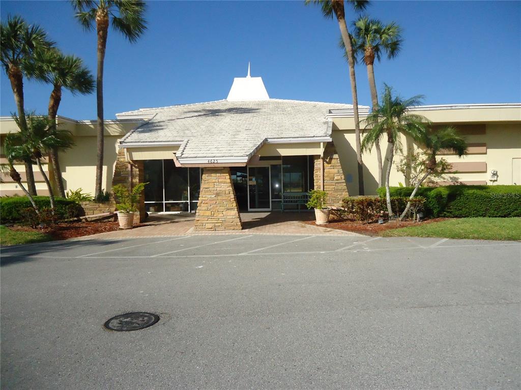 4550 Cove Circle, Unit 405 Madeira Beach, FL 33708 - Photo 12 of 20 a view of a house with palm trees