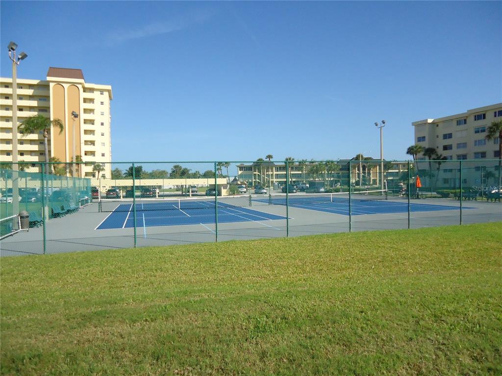 4550 Cove Circle, Unit 405 Madeira Beach, FL 33708 - Photo 13 of 20 a view of a swimming pool with a yard