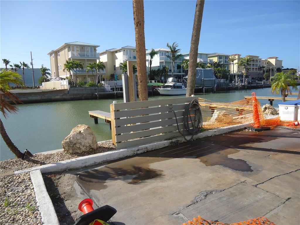 4550 Cove Circle, Unit 405 Madeira Beach, FL 33708 - Photo 18 of 20 a picture of a table and chairs in patio