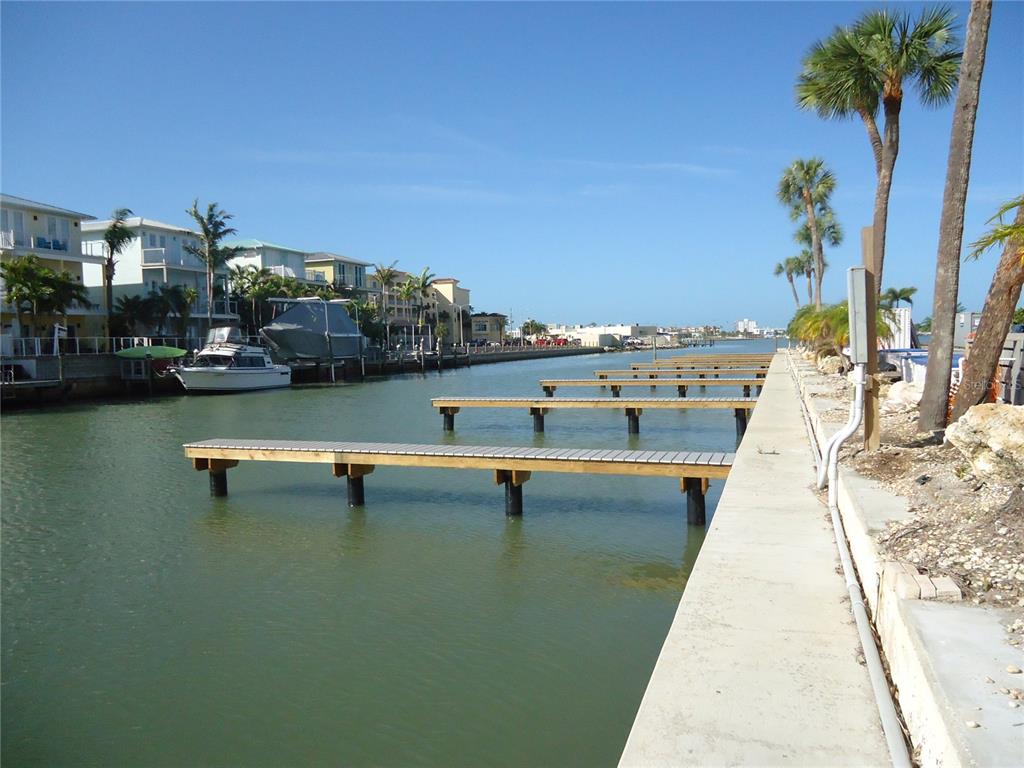 4550 Cove Circle, Unit 405 Madeira Beach, FL 33708 - Photo 19 of 20 a view of swimming pool with outdoor seating and lake view