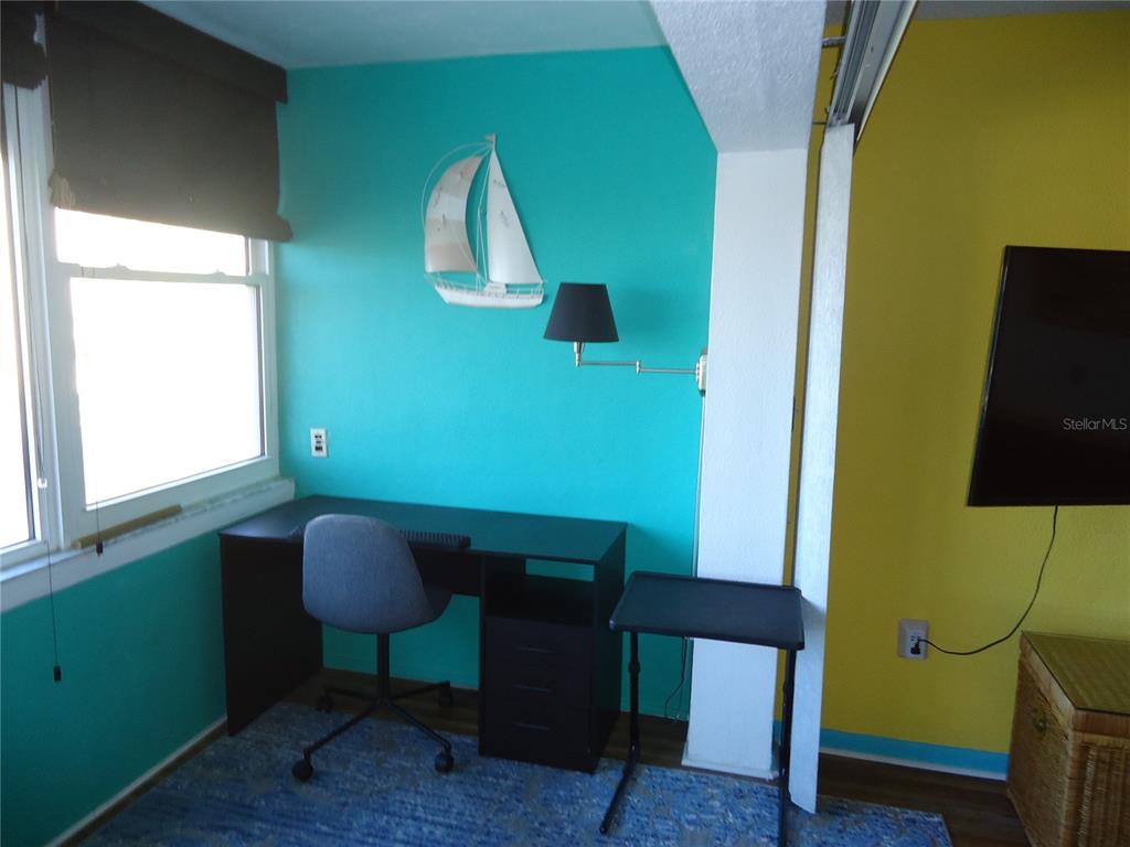 4550 Cove Circle, Unit 405 Madeira Beach, FL 33708 - Photo 7 of 20 a view of a room with furniture and a mirror