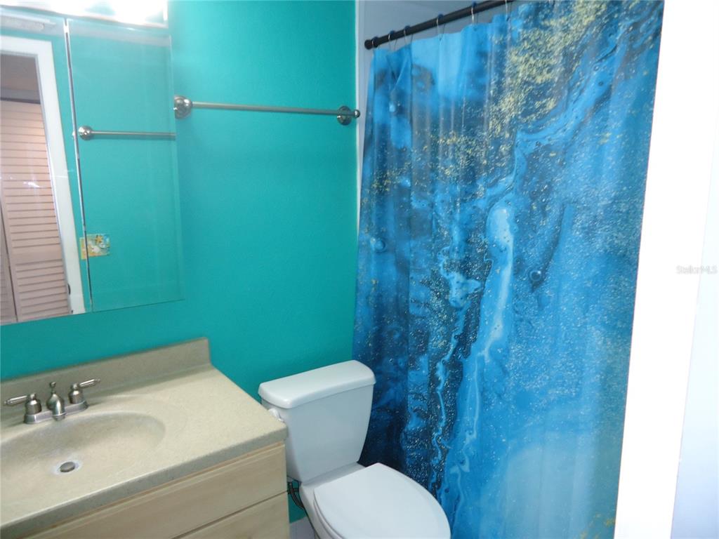 4550 Cove Circle, Unit 405 Madeira Beach, FL 33708 - Photo 8 of 20 a bathroom with a toilet and a sink
