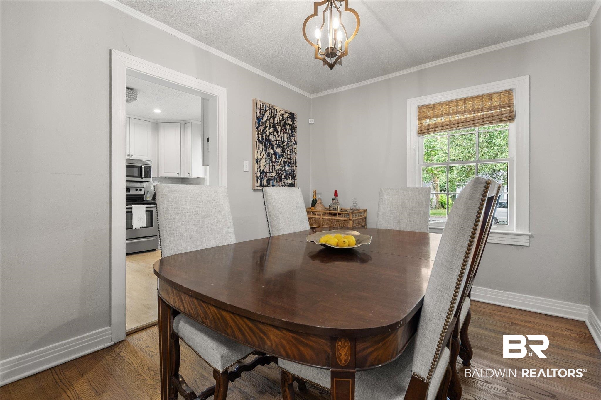 165 Crenshaw Street Mobile, AL 36606 - Photo 5 of 21 Dining area with ornamental molding, wood finished floors, and a chandelier