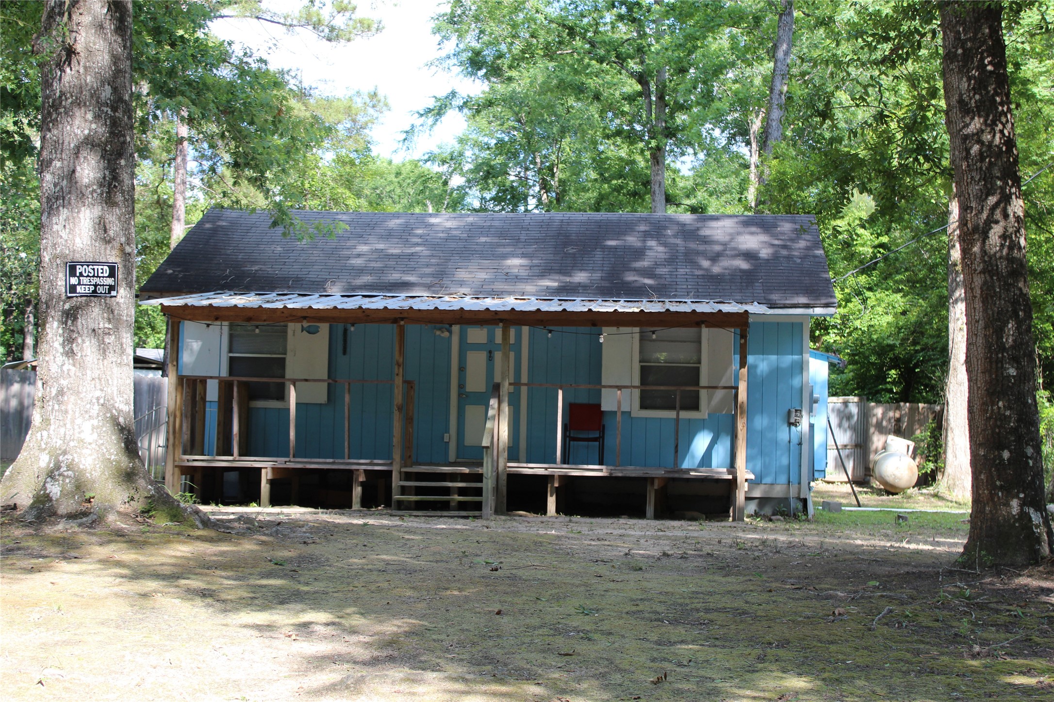 a front view of a house with a garden and yard