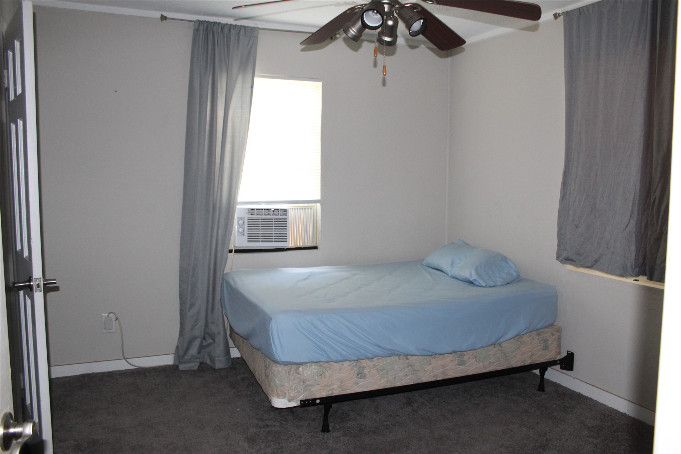 400 Carson Roberson Road Livingston, TX 77351 - Photo 15 of 19 a bedroom with a bed and a window