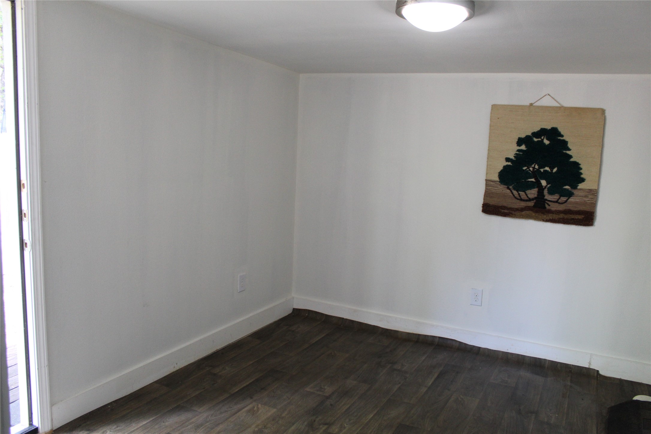 400 Carson Roberson Road Livingston, TX 77351 - Photo 17 of 19 a room with a wooden floor and a window