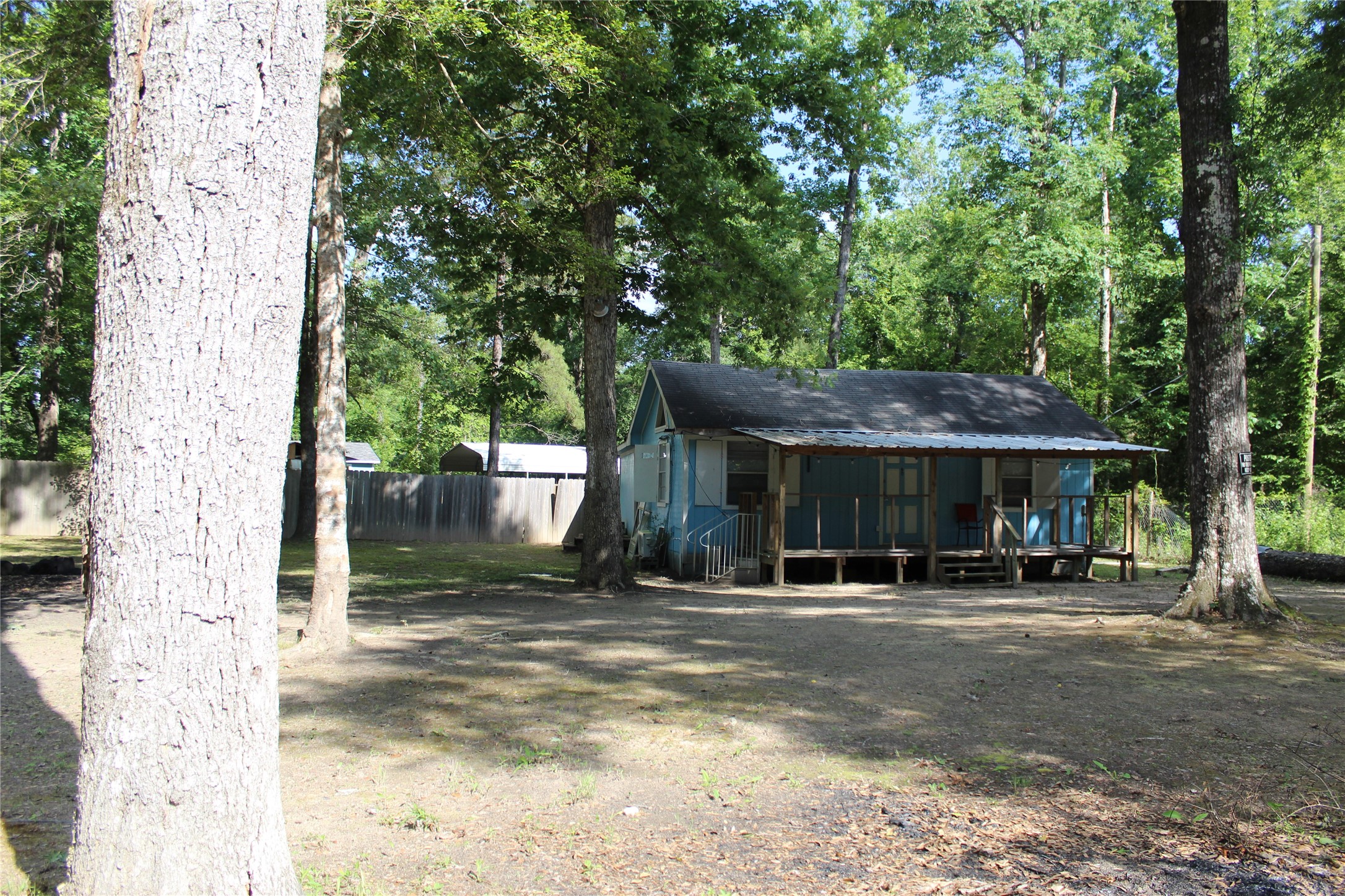 400 Carson Roberson Road Livingston, TX 77351 - Photo 4 of 19 a backyard of a house with table and chairs