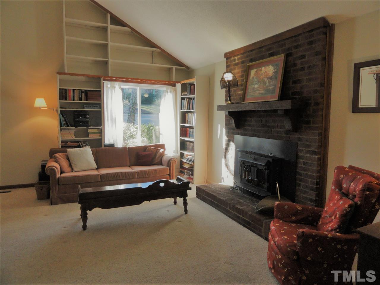 403 Ryan Road Cary, NC 27511 - Photo 3 of 21 A vaulted ceiling adds depth to this large living room. Note the built-in bookshelves.