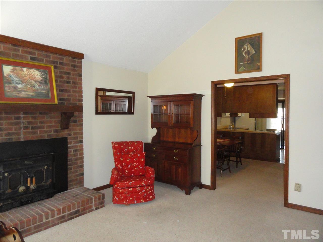 403 Ryan Road Cary, NC 27511 - Photo 4 of 21 Another view of the living room. A wood burning stove is inserted in the fireplace.