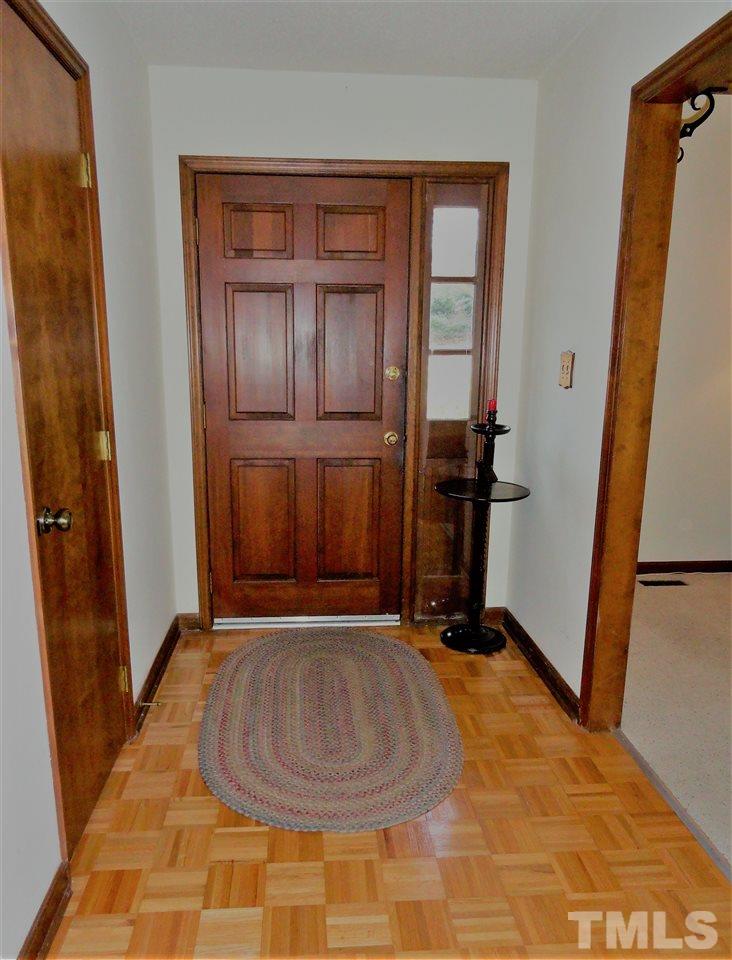 403 Ryan Road Cary, NC 27511 - Photo 5 of 21 Attractive wood door and wood floor in the entrance hall.