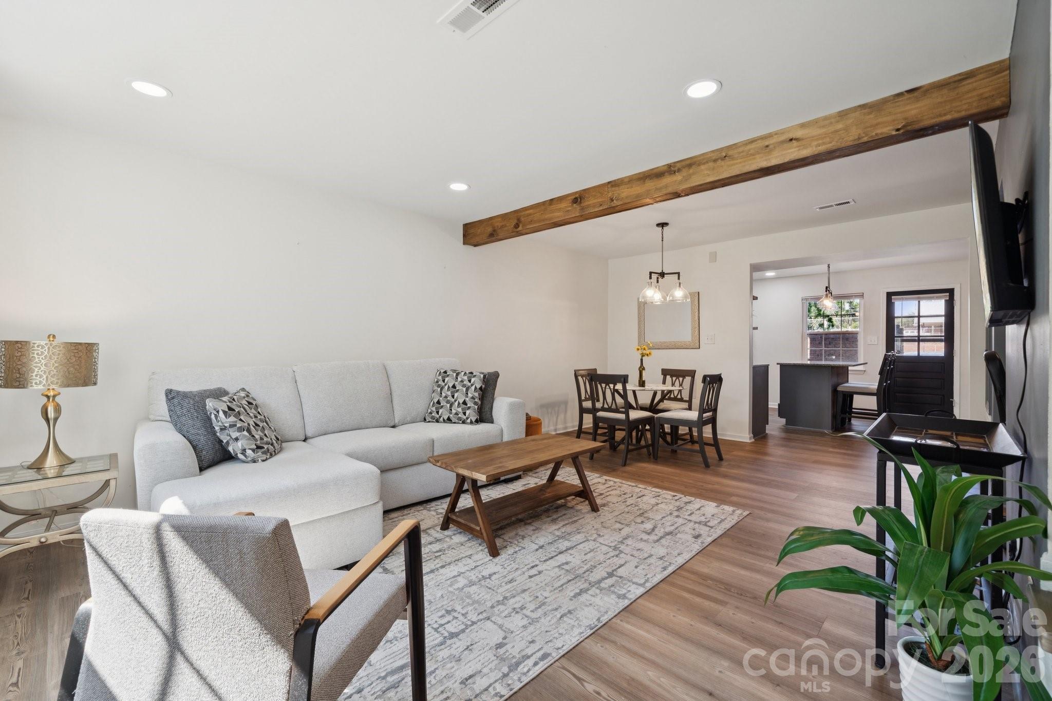 a living room with furniture and wooden floor