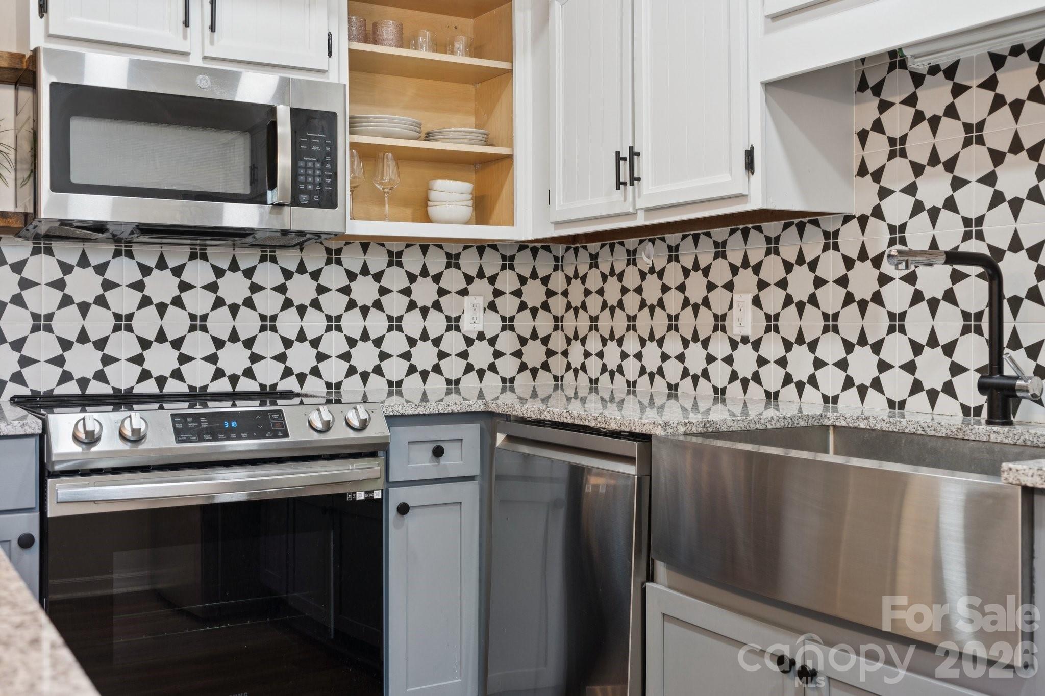 8838 Hunter Ridge Drive Charlotte, NC 28226 - Photo 12 of 27 a kitchen with a stove and a microwave