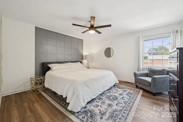 a bedroom with a bed couch and a window