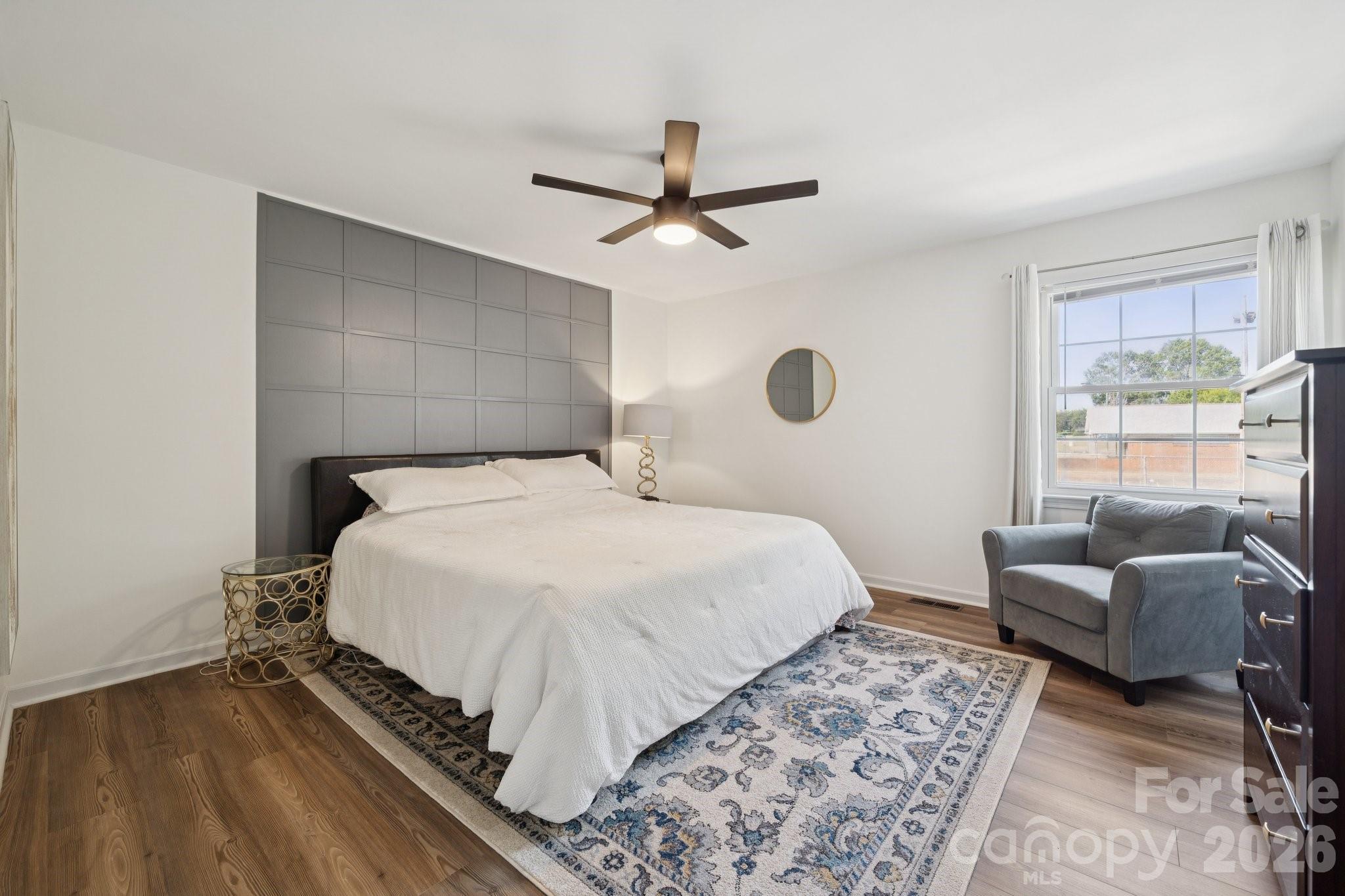 8838 Hunter Ridge Drive Charlotte, NC 28226 - Photo 15 of 27 a bedroom with a bed couch and a window