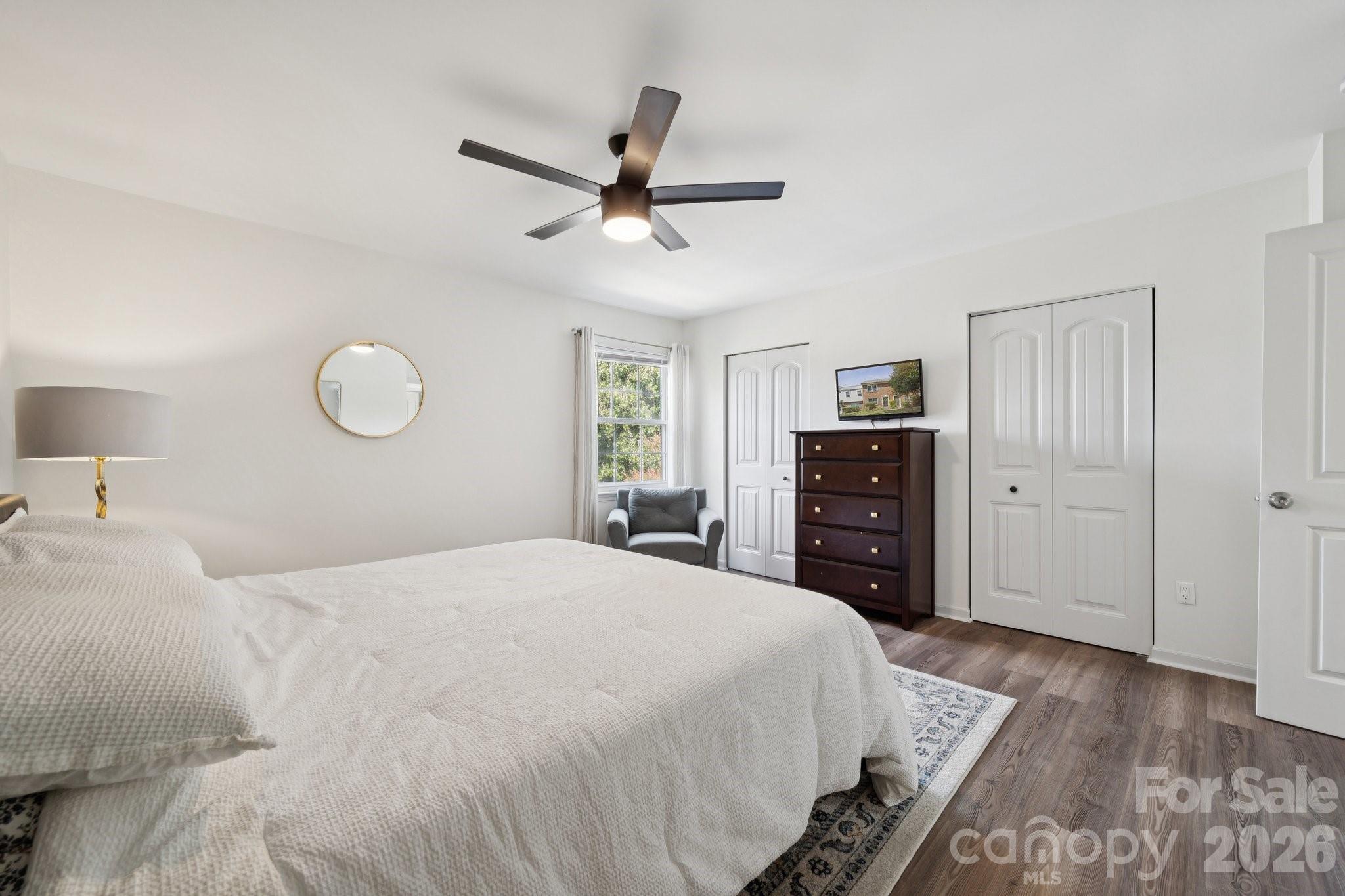 8838 Hunter Ridge Drive Charlotte, NC 28226 - Photo 16 of 27 a bedroom with a large bed and a chandelier