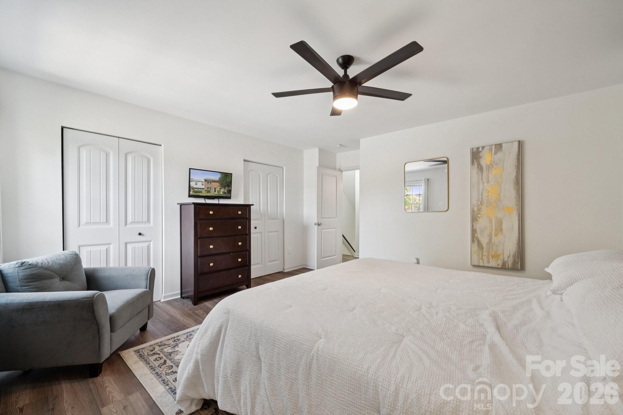 8838 Hunter Ridge Drive Charlotte, NC 28226 - Photo 17 of 27 a spacious bedroom with a bed a couch and a chandelier