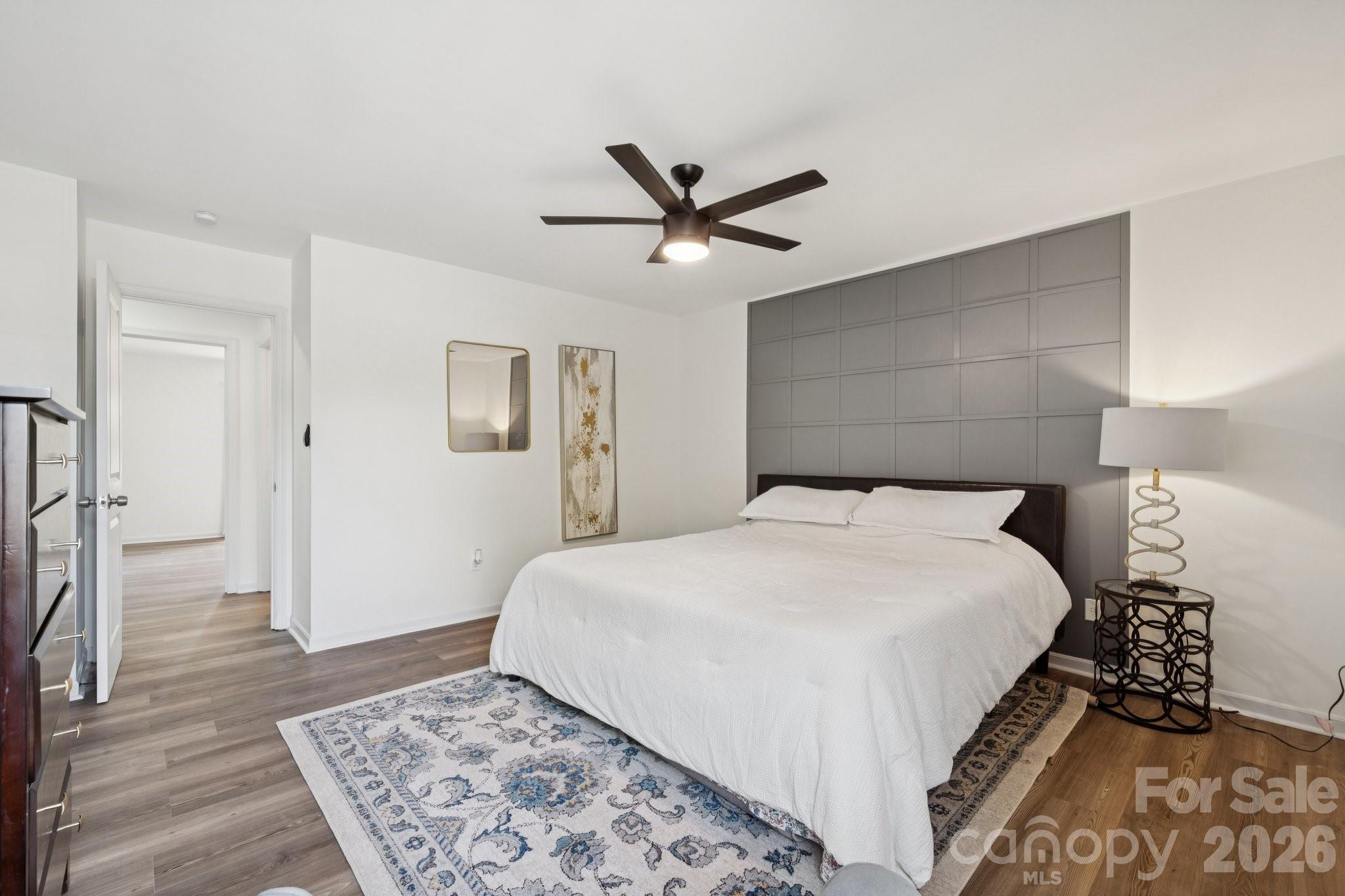 8838 Hunter Ridge Drive Charlotte, NC 28226 - Photo 18 of 27 a bedroom with a large bed and a chandelier