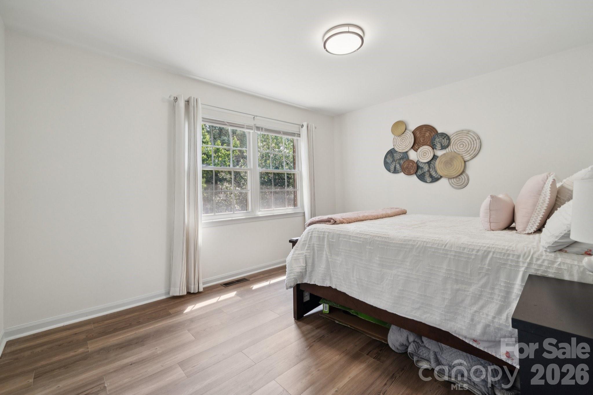 8838 Hunter Ridge Drive Charlotte, NC 28226 - Photo 21 of 27 a bedroom with a bed and a window